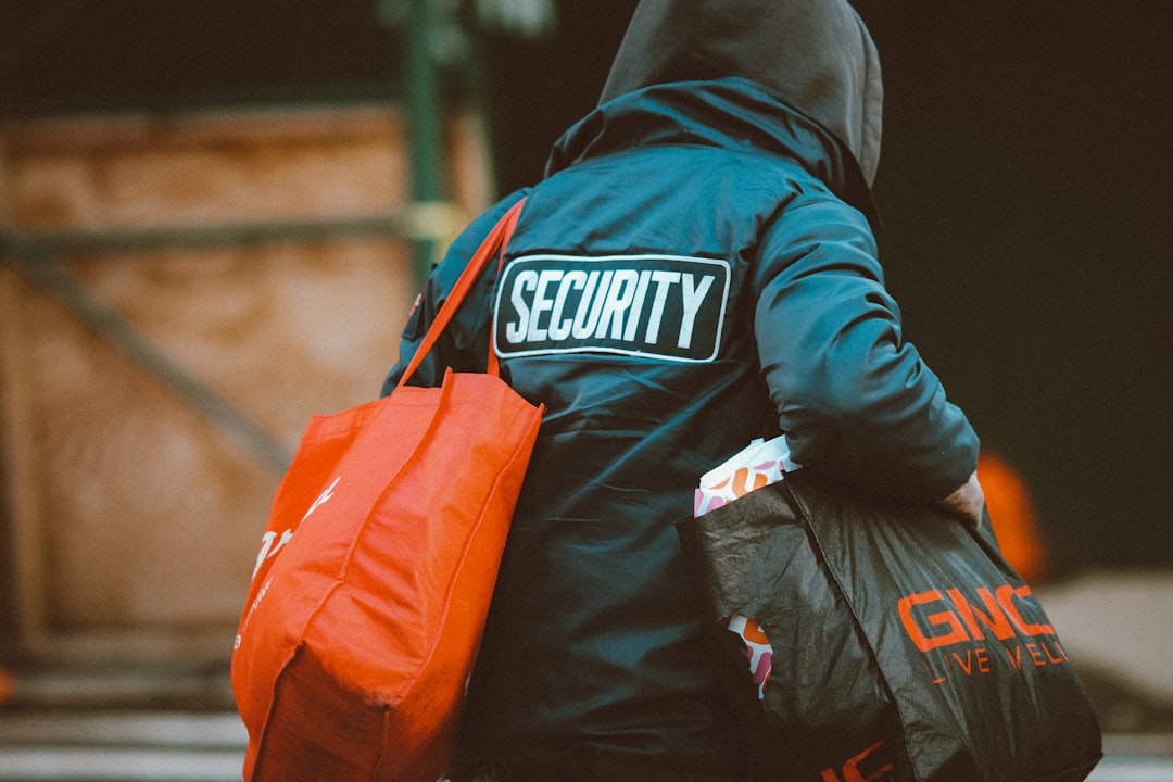 man in black and orange jacket with orange and black backpack