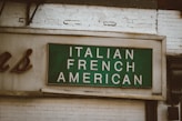 green and white wooden wall mounted signage