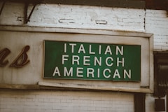 green and white wooden wall mounted signage