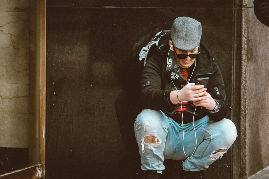 man in black jacket and gray knit cap