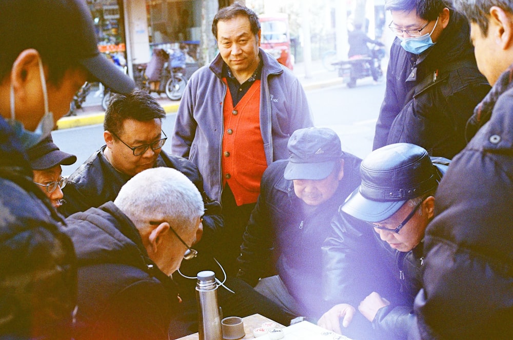 man in blue button up shirt wearing white cap