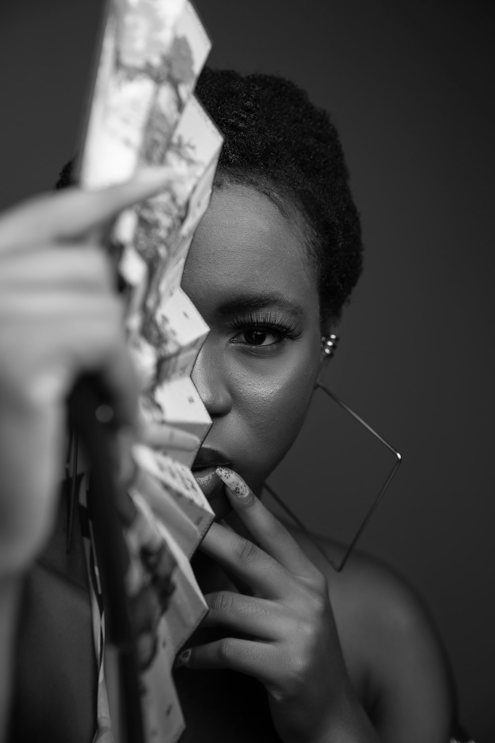 woman holding a banknote in grayscale photography