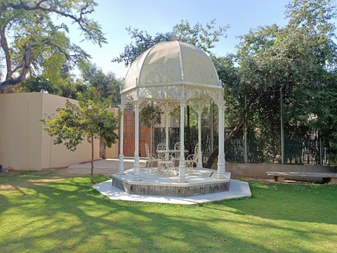 A spacious gazebo with comfortable seating and hanging plants
