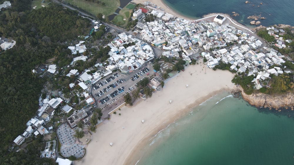 aerial view of city buildings near body of water during daytime