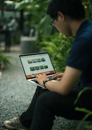 boy in blue t-shirt using white tablet computer