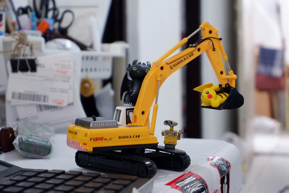 yellow and black excavator toy