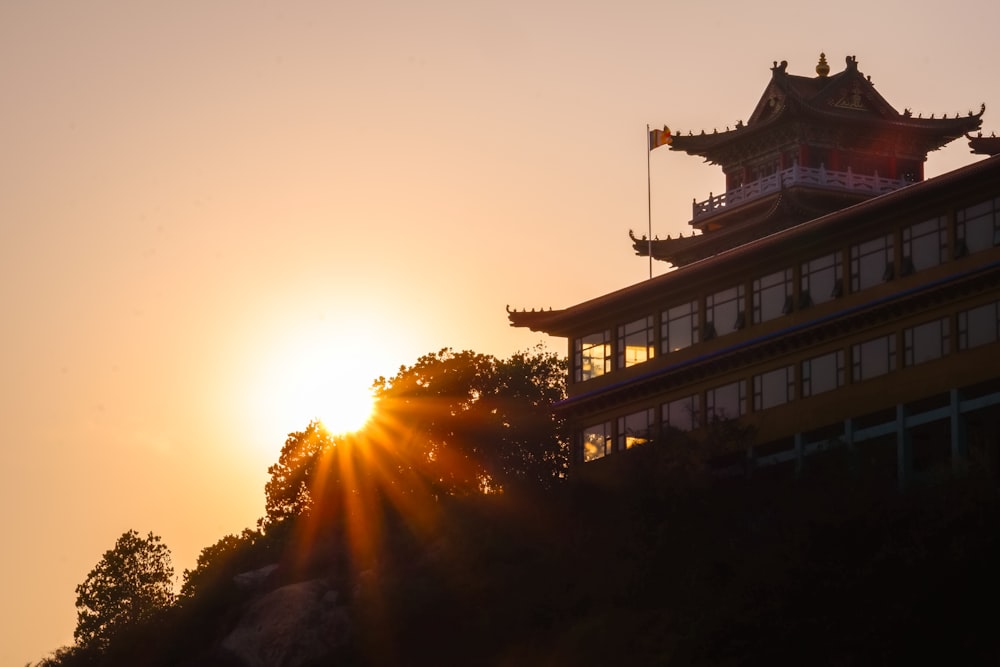 brown and white temple on top of hill during sunset