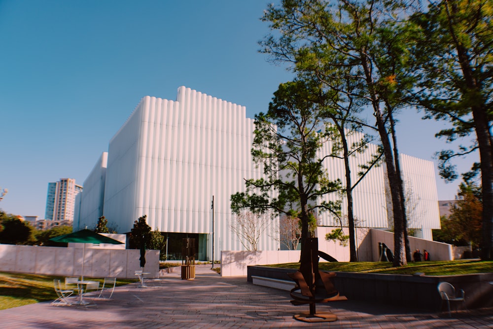 green trees near white concrete building during daytime