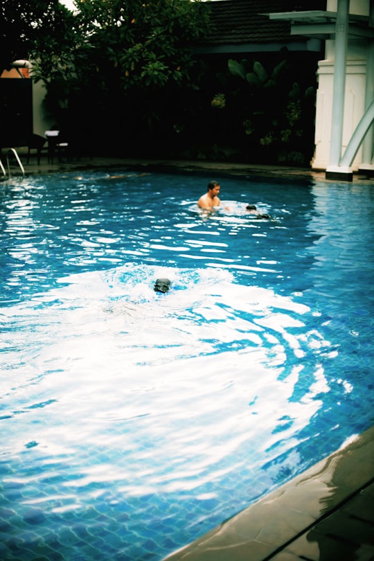 woman in swimming pool during daytime in Yogyakarta Indonesia