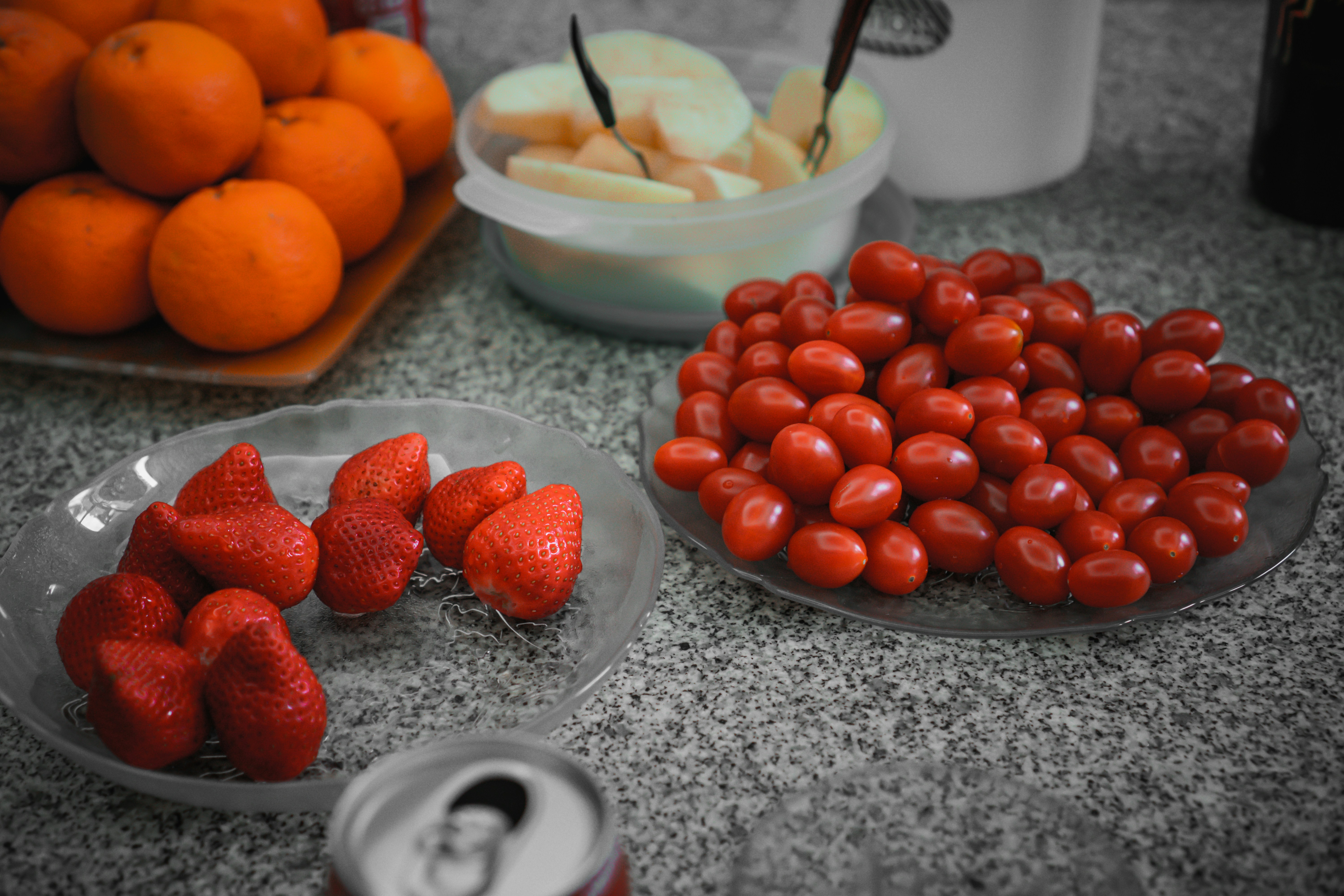 strawberries and orange fruits on white ceramic bowl, 