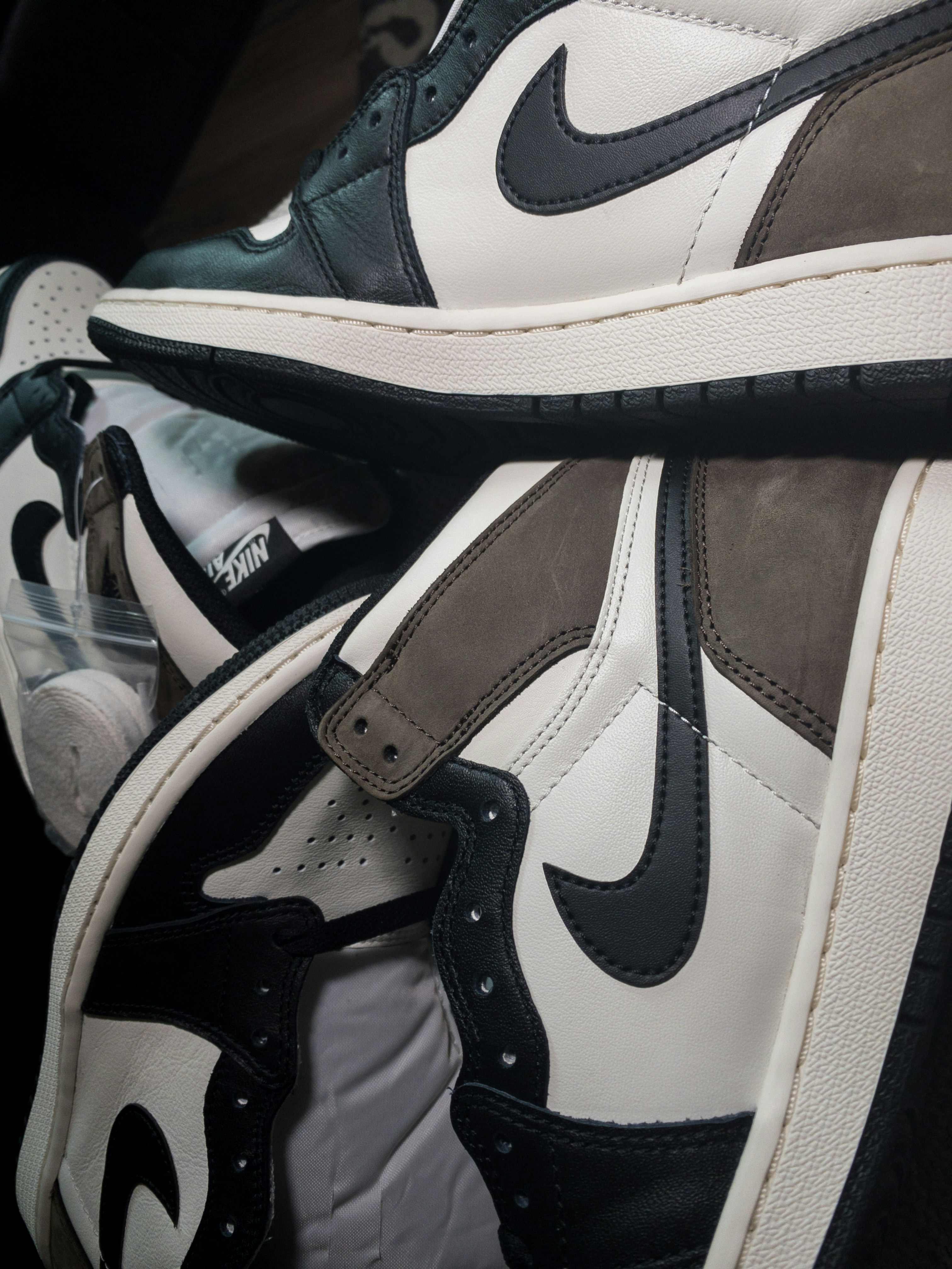 Nike Air Jordan 1 sneaker top-down view showing toe box and lacing on dark matte surface
