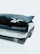 Close-up of a neatly folded stack of men's minimalist t-shirts with subtle branding.