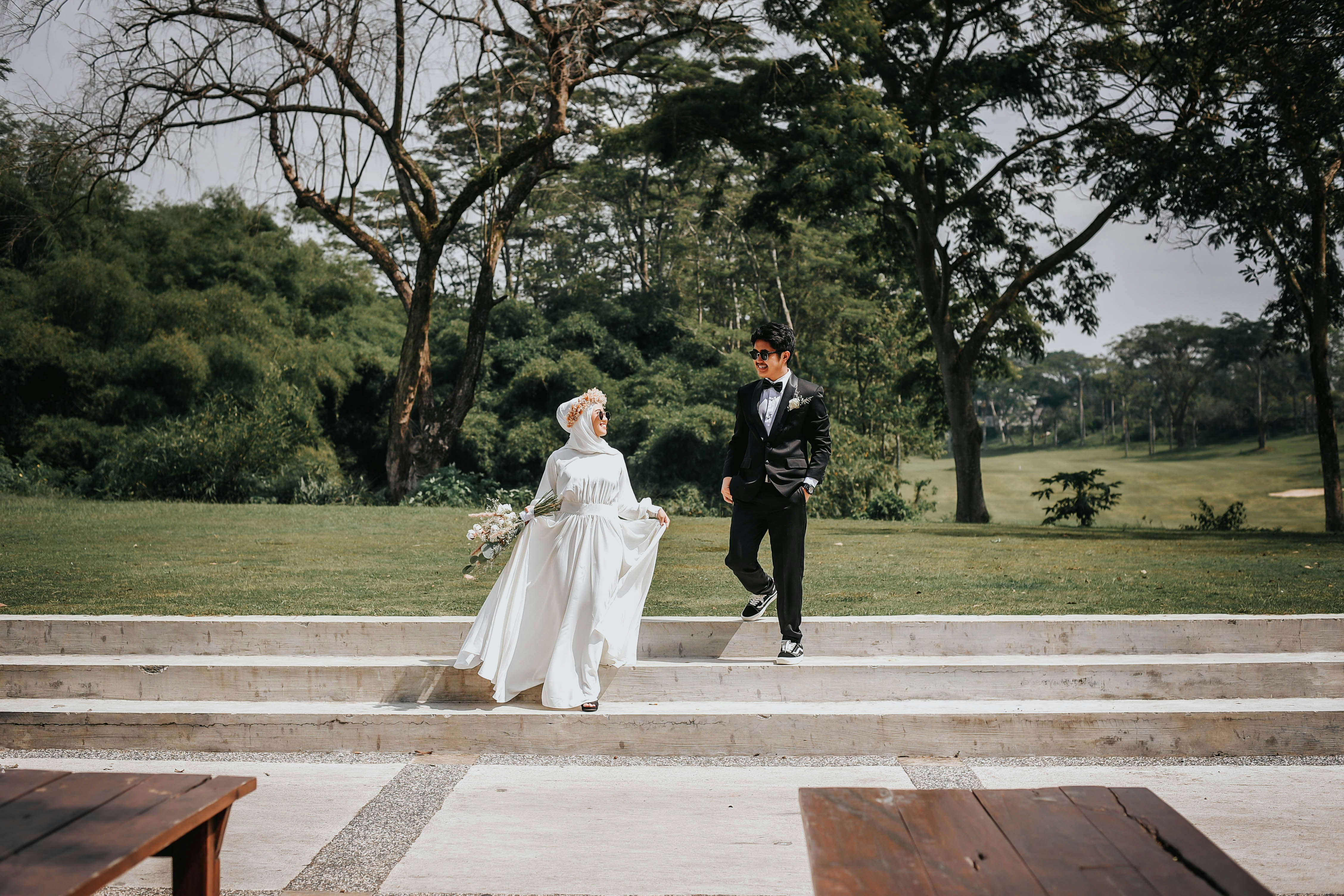 man and woman walking on sidewalk during daytime