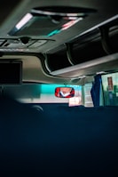 A driver inspecting the load inside a contract vehicle under bright sunlight.