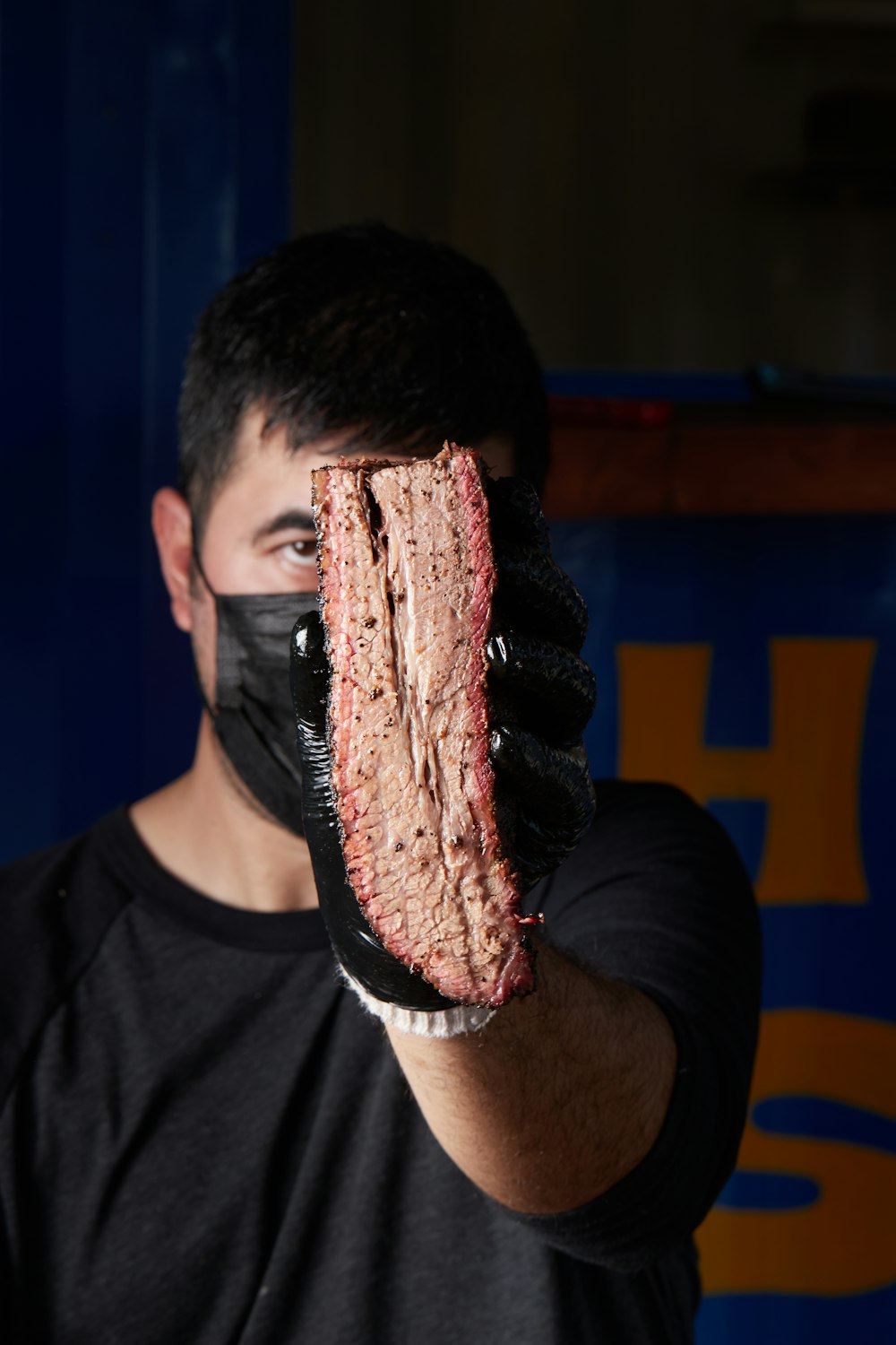 man in black crew neck t-shirt with red paint on face