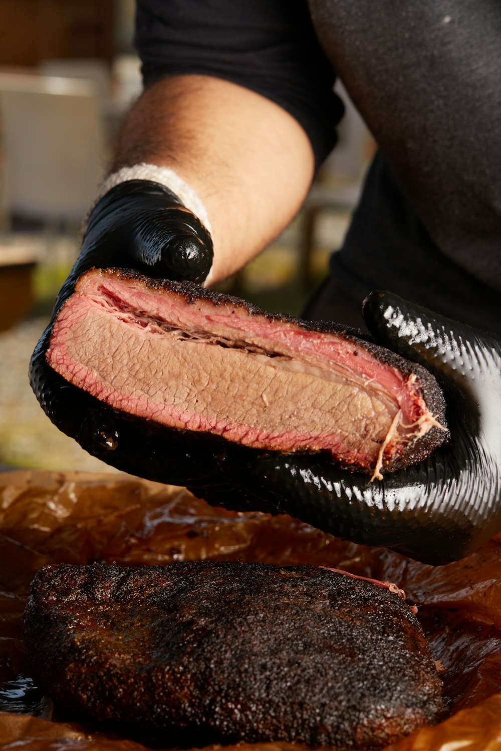 person holding raw meat during daytime