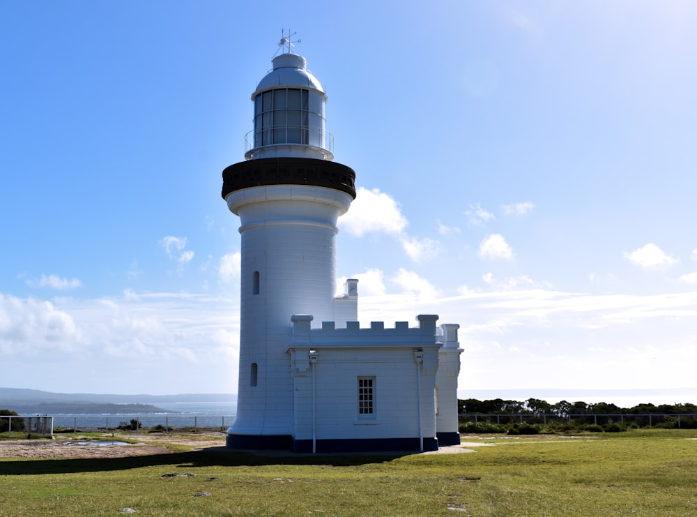 white and black lighthouse under blue sky during daytime