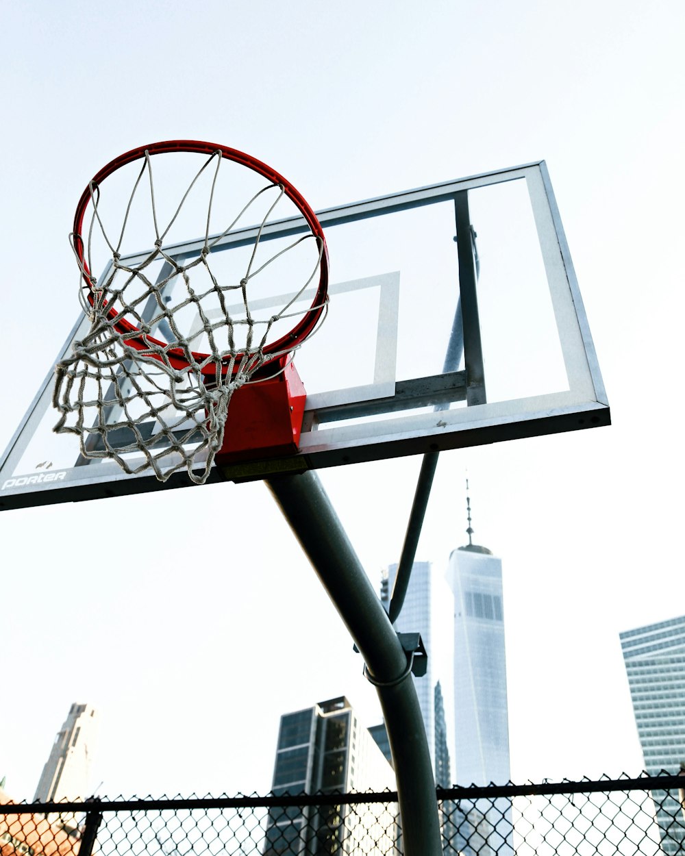 a basketball hoop with a city in the background