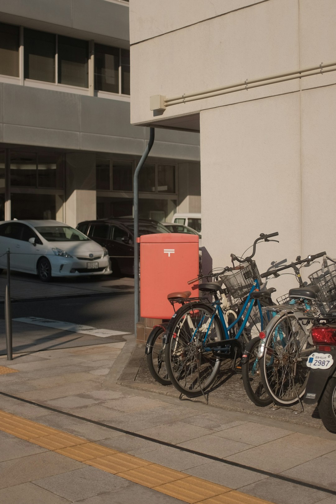 blue and black city bikes parked beside white car