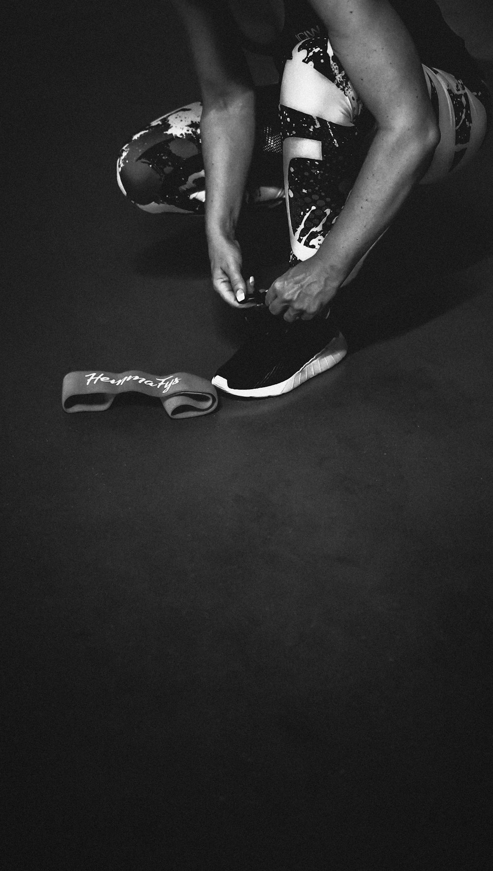 Foto en escala de grises de una persona con zapatillas de deporte