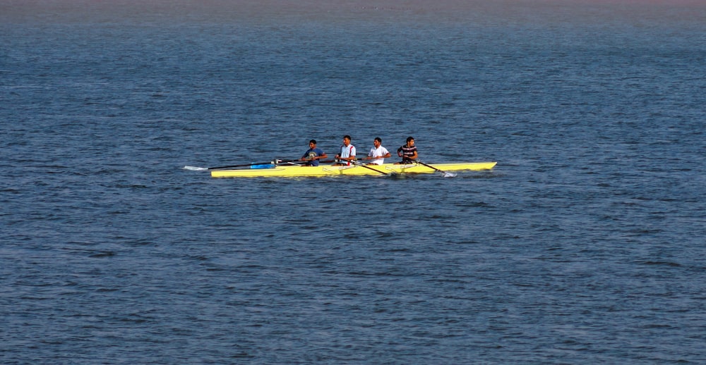 2 person riding yellow kayak on sea during daytime