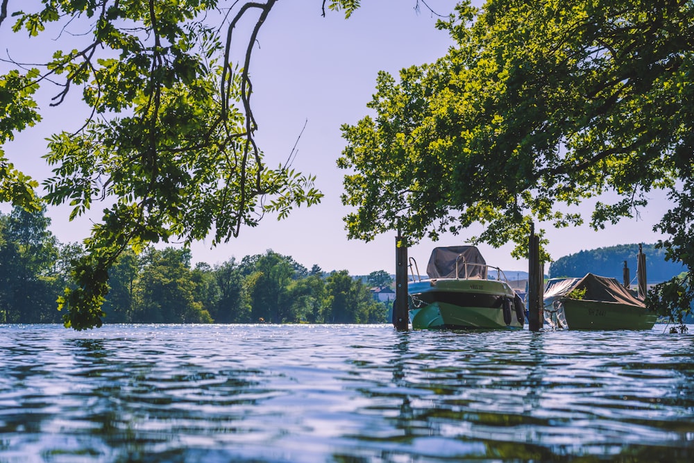 green boat on body of water during daytime