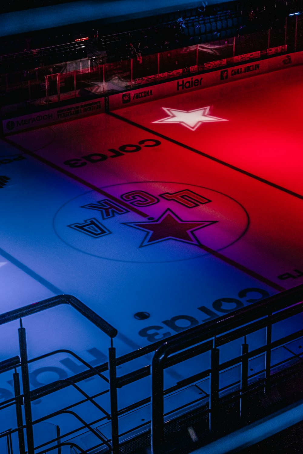a hockey rink lit up with red, white and blue lights