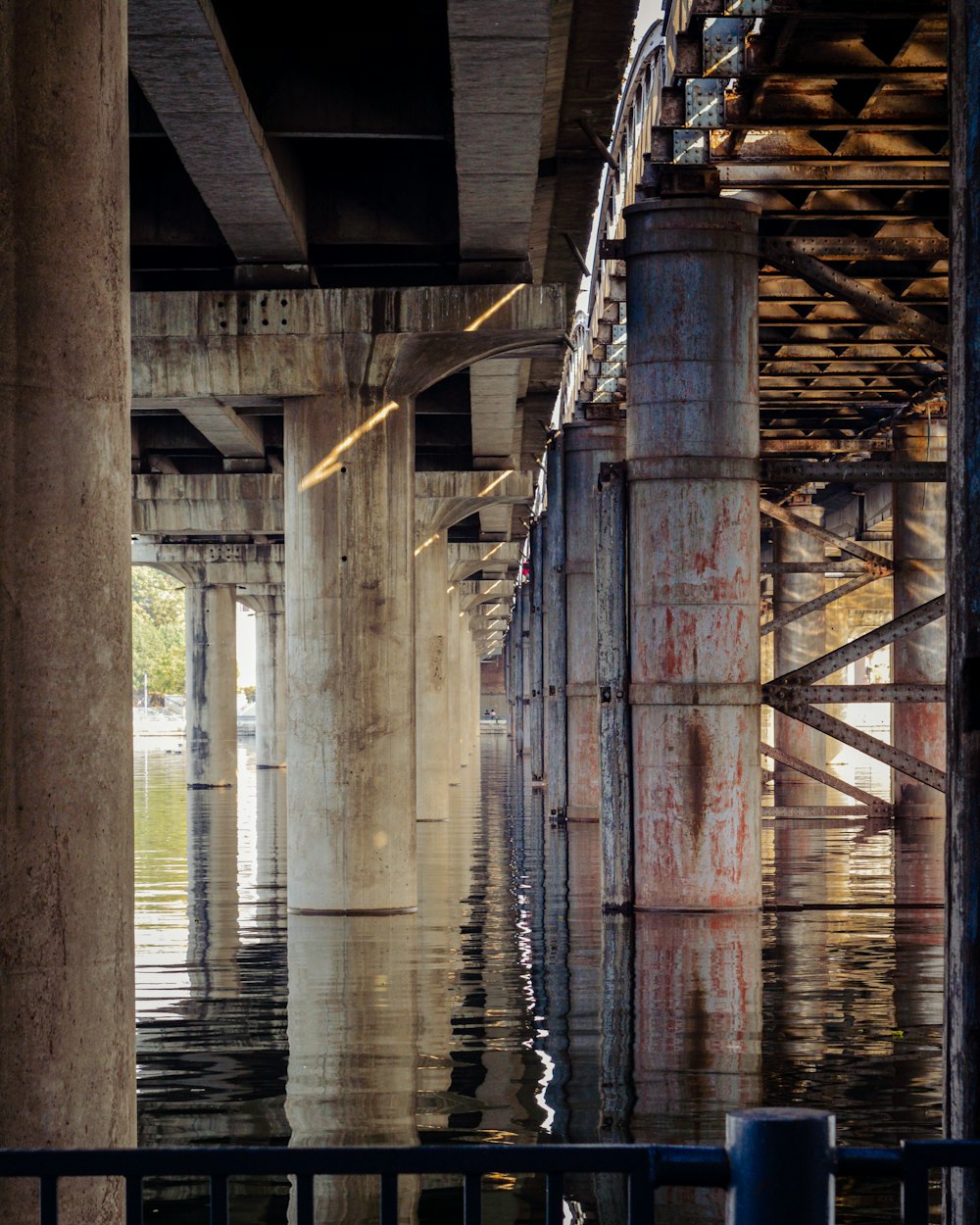 brown wooden bridge over water during daytime