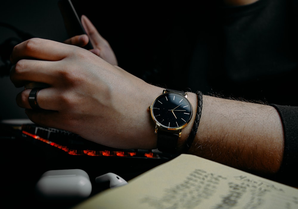 person wearing black analog watch