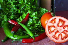 Close-up of fresh, vibrant vegetables and grains arranged on a rustic wooden table, highlighting natural nutrition.
