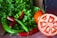 Close-up of fresh vegetables arranged on a wooden table in natural light.