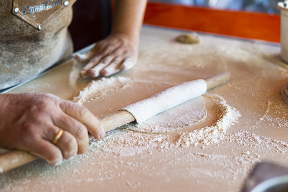 person holding white rolling pin
