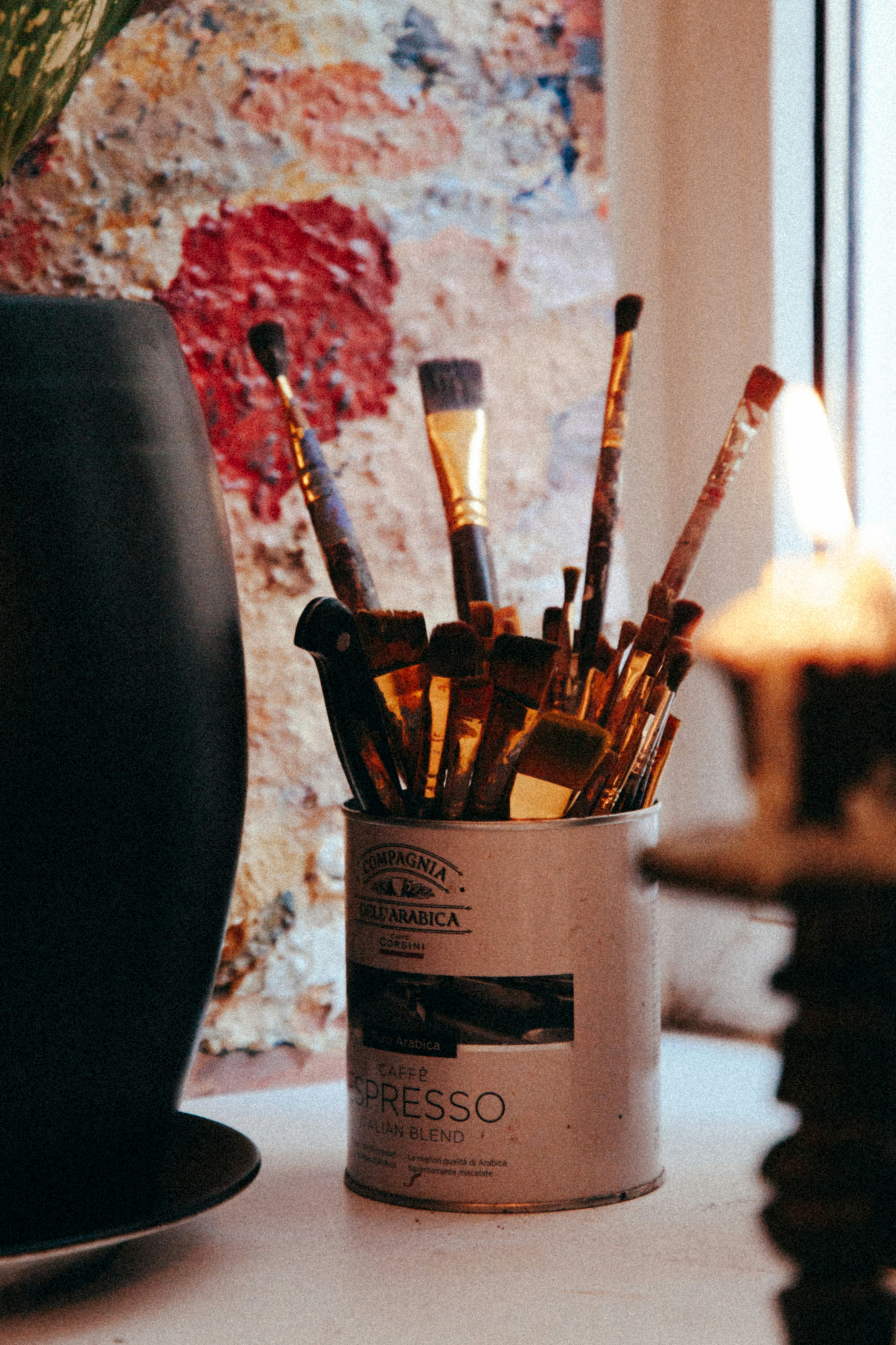 paint brushes in white ceramic mug