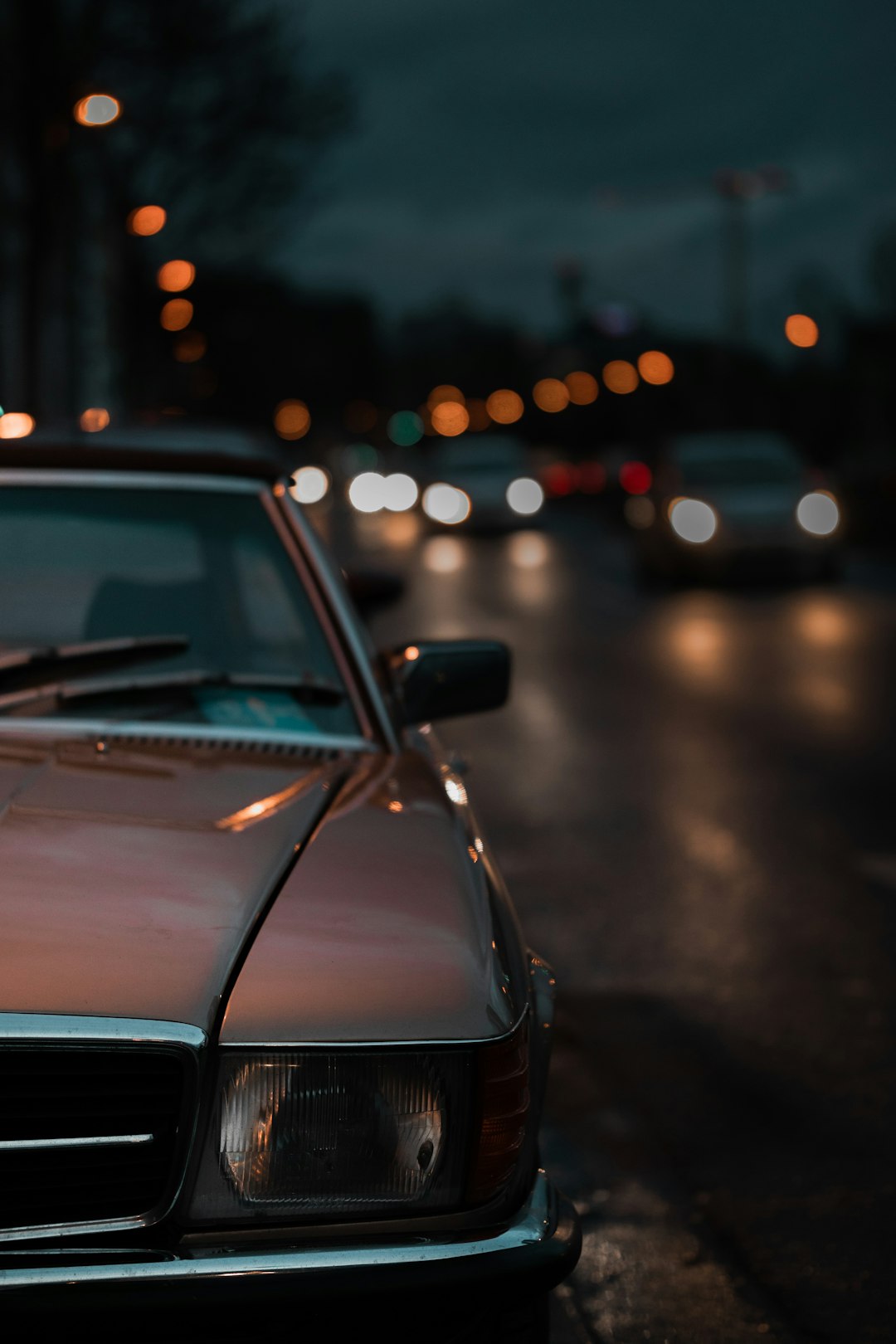 red car on road during night time