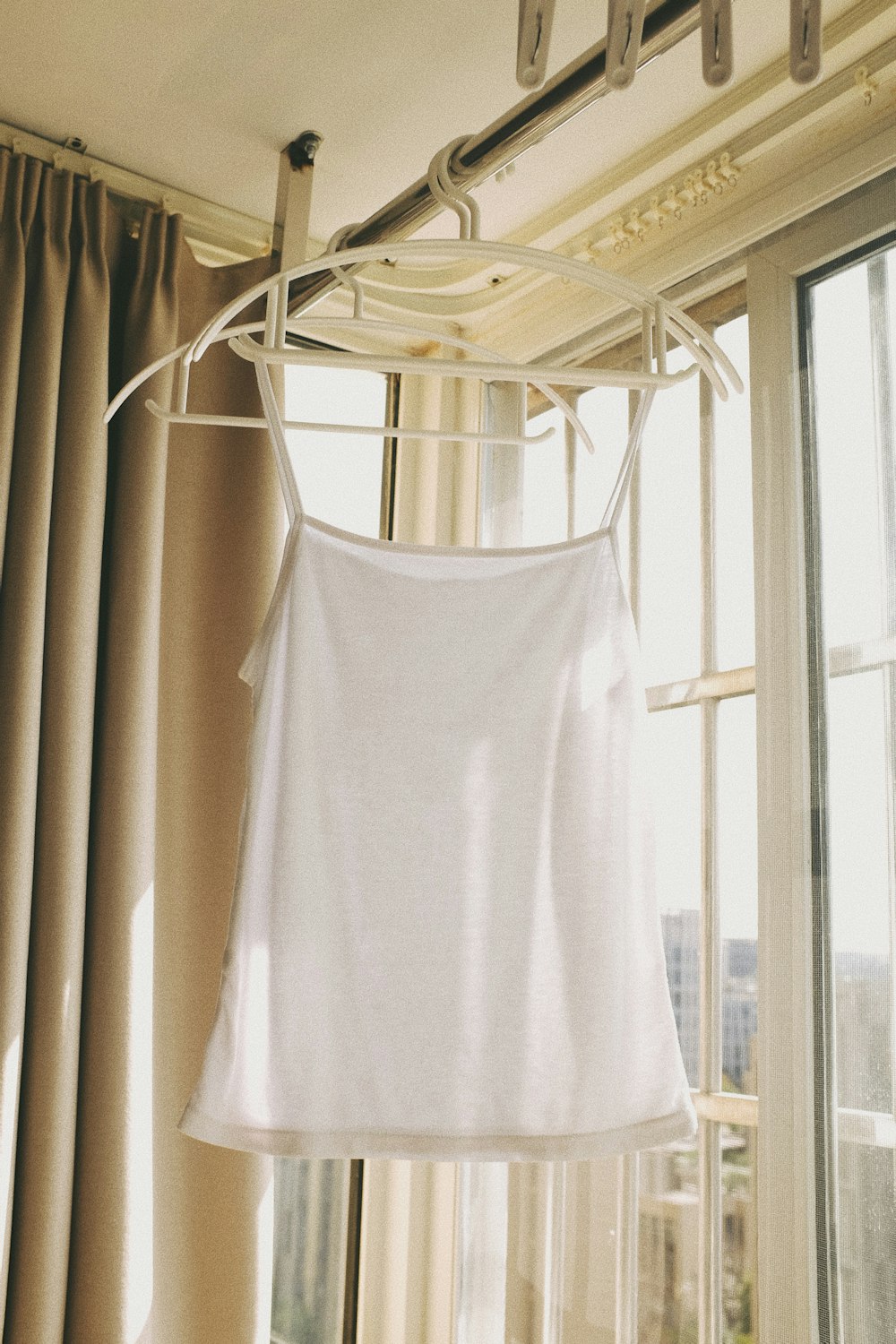 white tank top on white clothes hanger