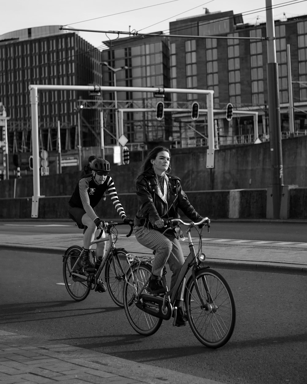 grayscale photo of 2 women riding on bicycle