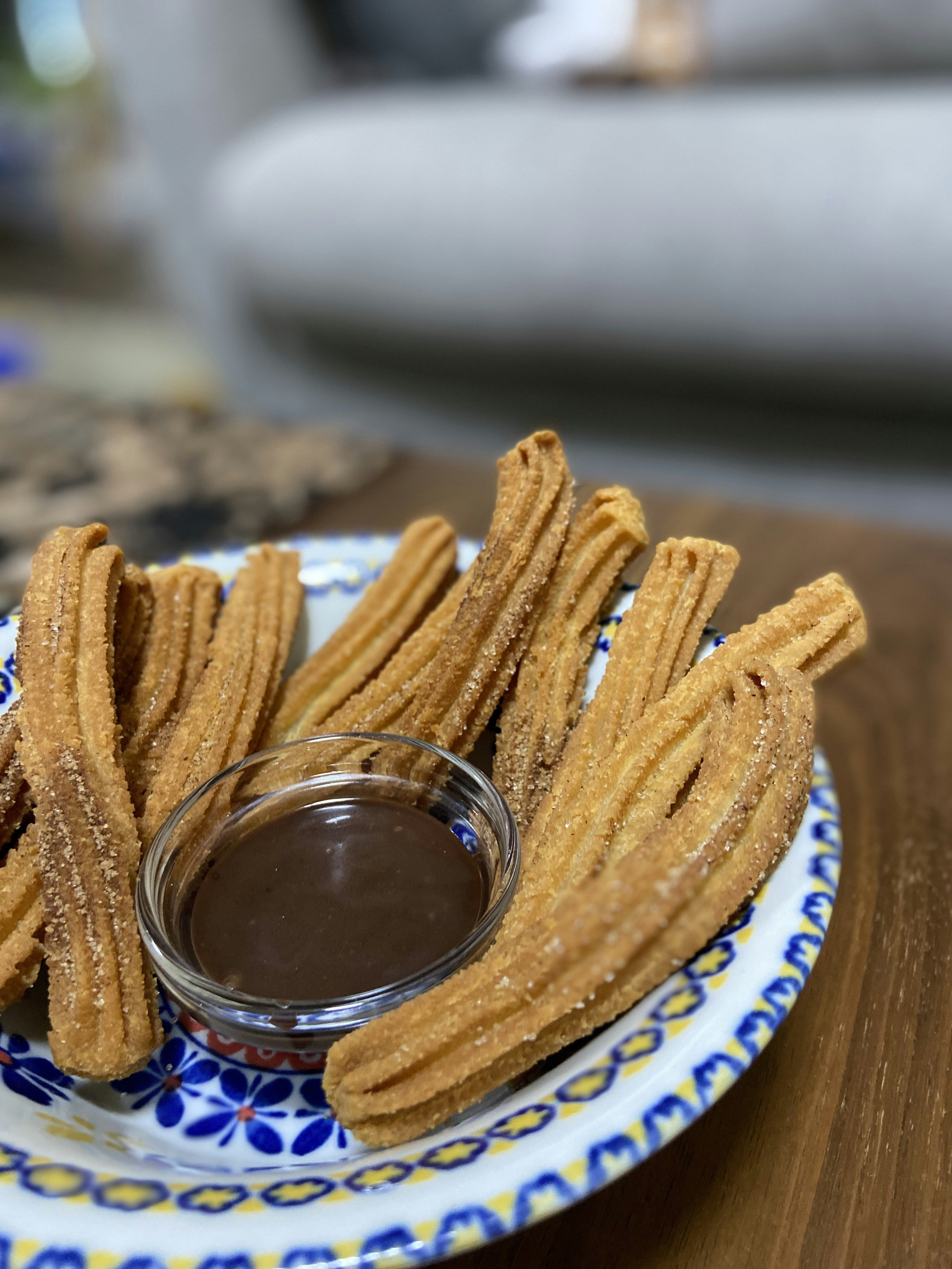 Golden churro bites with cinnamon sugar and chocolate sauce, bright food photography