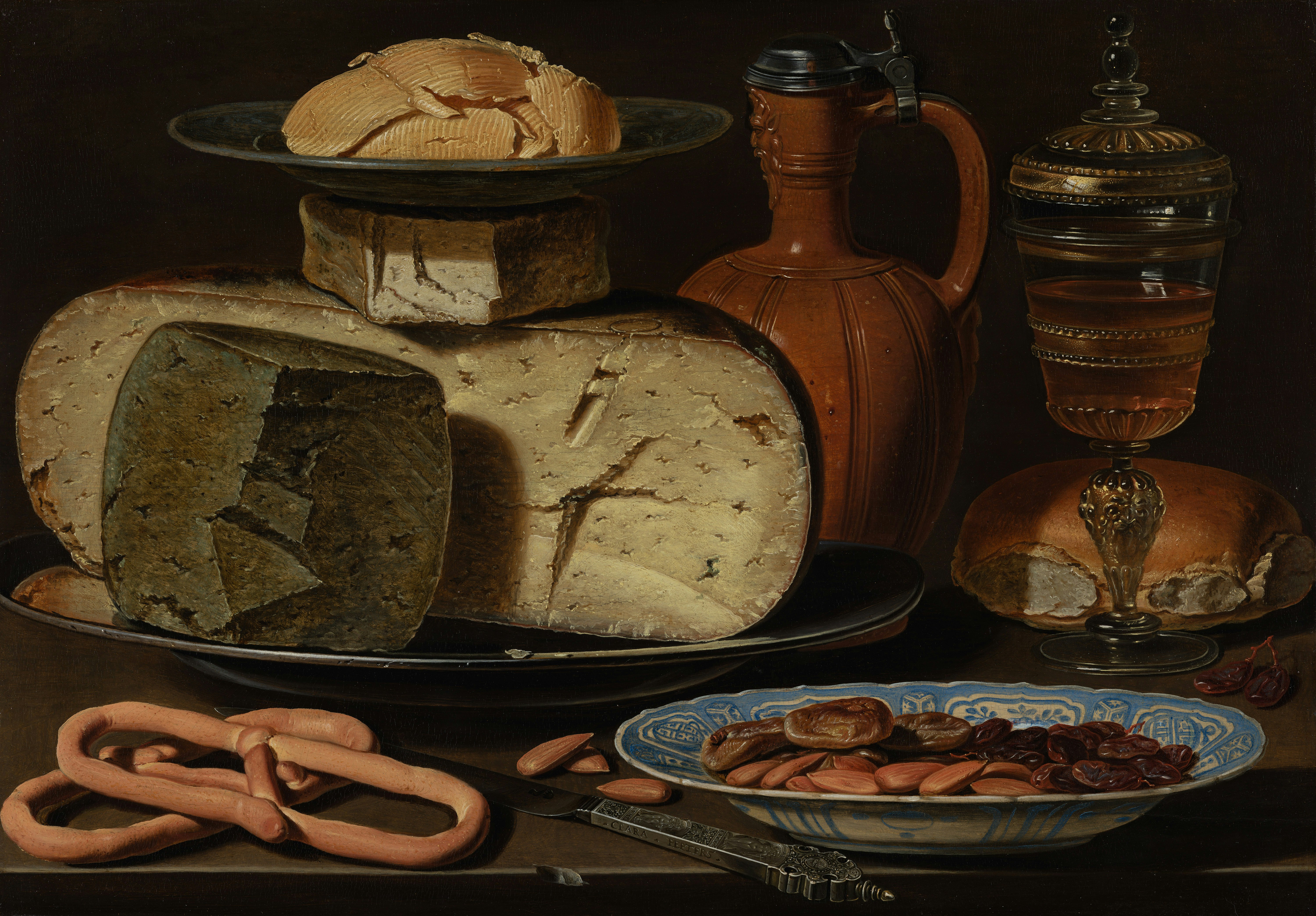 The Antwerp painter Clara Peeters was one of the first food still-life painters, and her ‘banketjes’ or banquet pieces had a great influence on the painters of the Northern Netherlands<br />Title: Still Life with Cheeses, Almonds and Pretzels. Creator: Clara Peeters. Institution: Mauritshuis. Provider: Digitale Collectie. Providing Country: Netherlands. Public Domain. Source:https://www.europeana.eu/item/2021672/resource_document_mauritshuis_1203. To know more: https://www.europeana.eu/galleries/art-by-female-artists