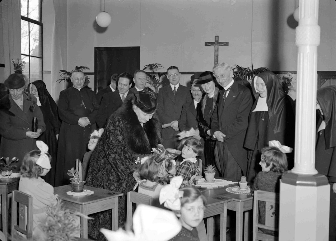 group of people standing in front of table