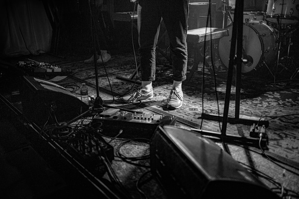 grayscale photo of man playing guitar