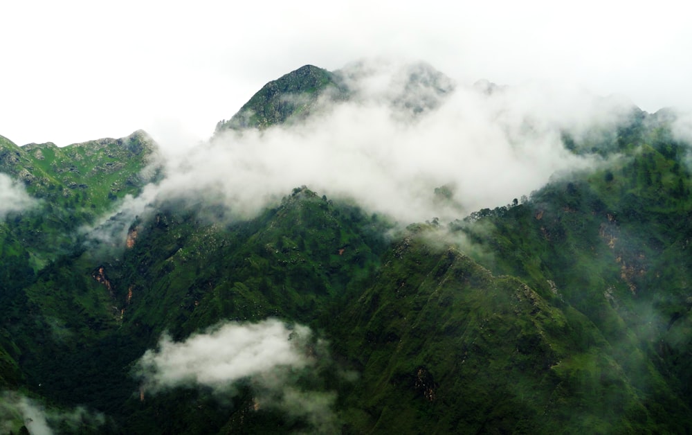 green mountain covered with clouds