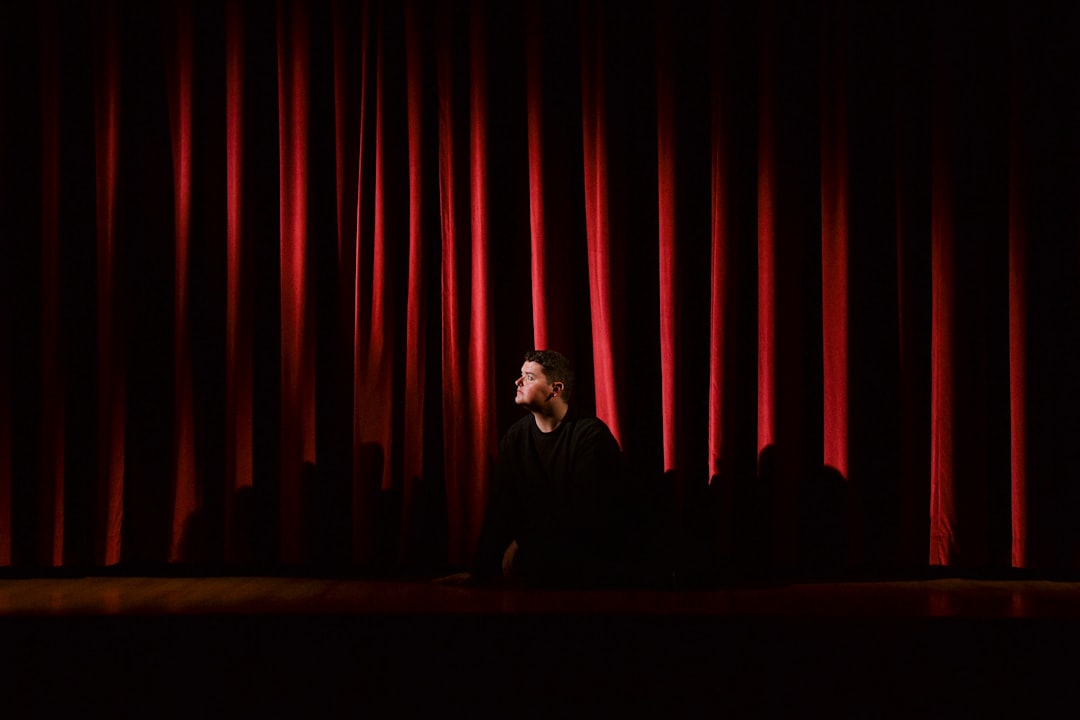 Man on stage in a theater.