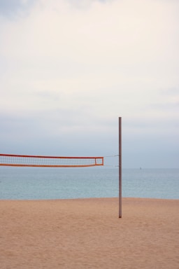 negative space for photo composition,how to photograph orange and white striped hammock on beach during daytime