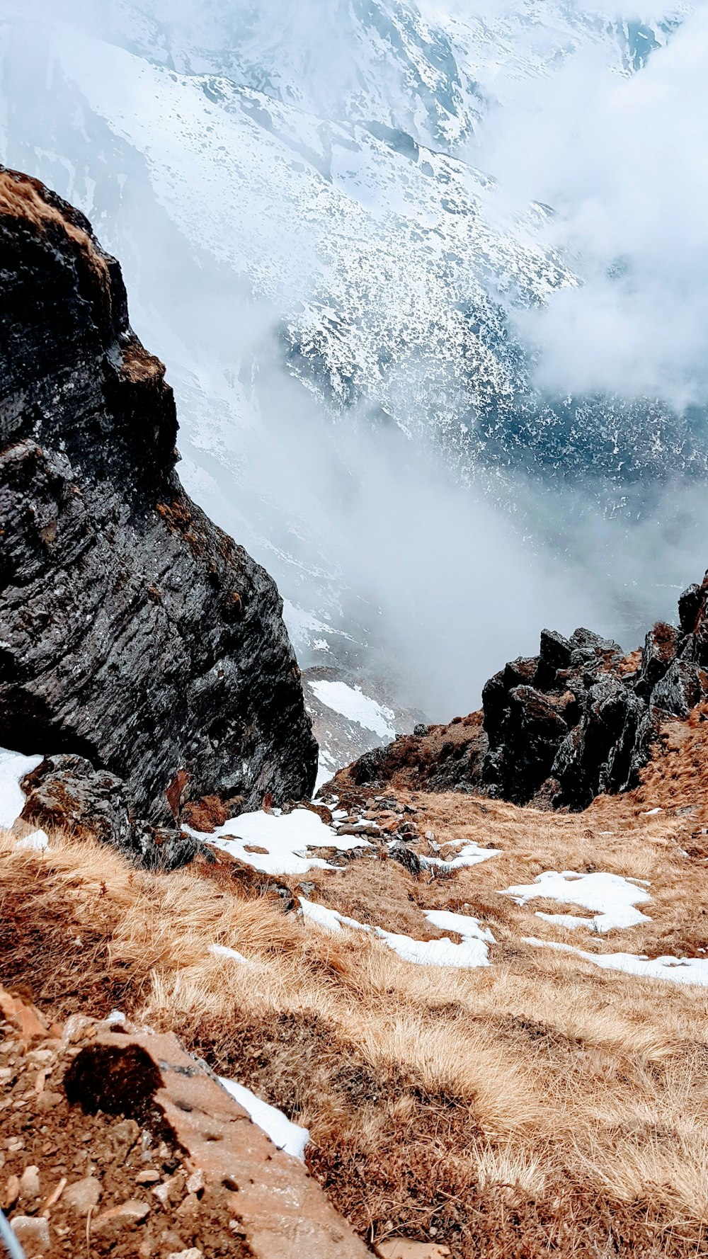 brown rocky mountain with white clouds