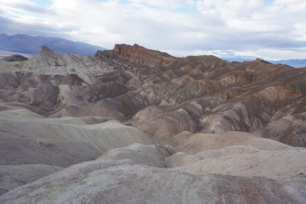 brown and gray rocky mountain under white cloudy sky during daytime