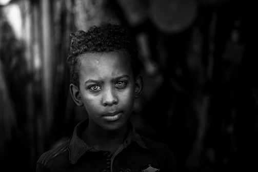 Close-up photo of a student with a sharp black background.
