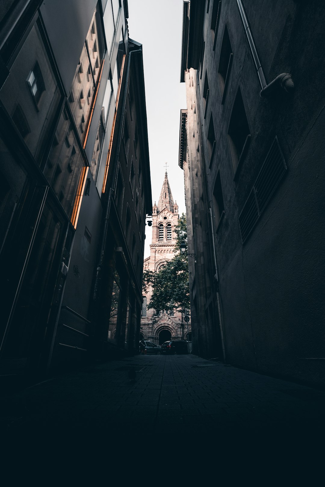 grayscale photo of a street in between of buildings