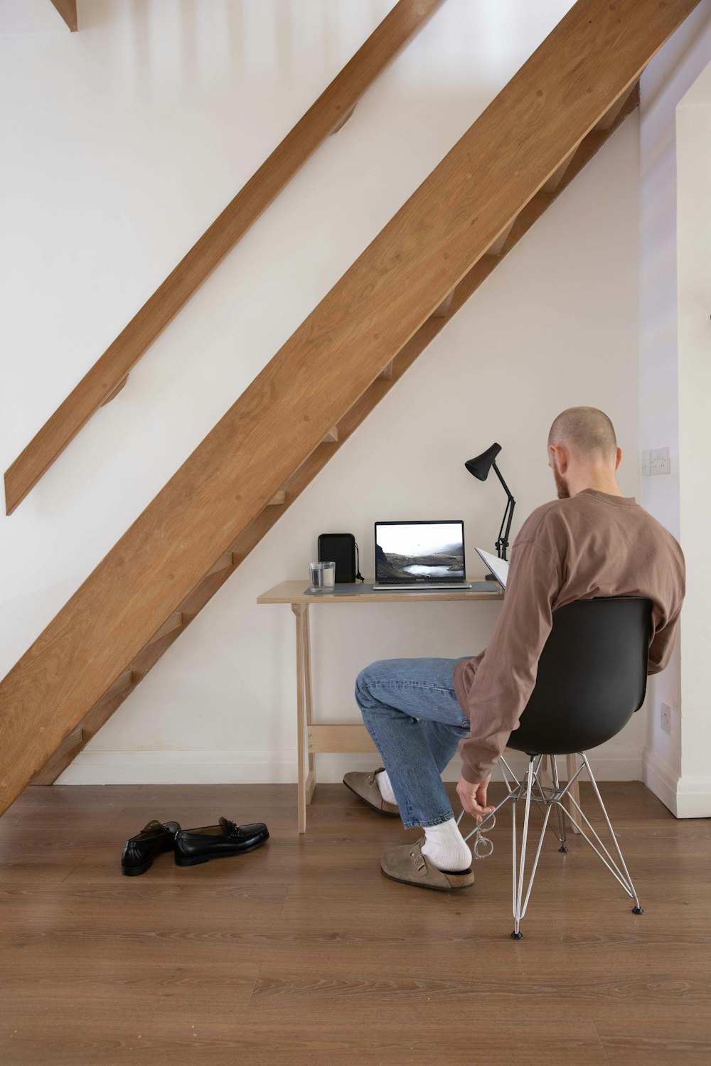 man in brown shirt sitting on chair