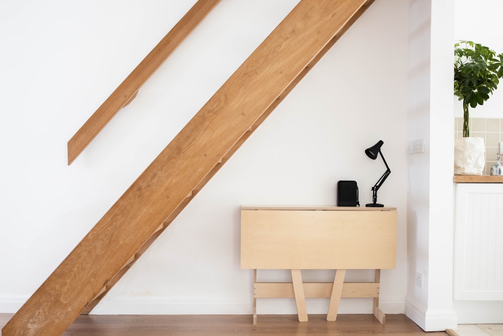 brown wooden chair beside white wall