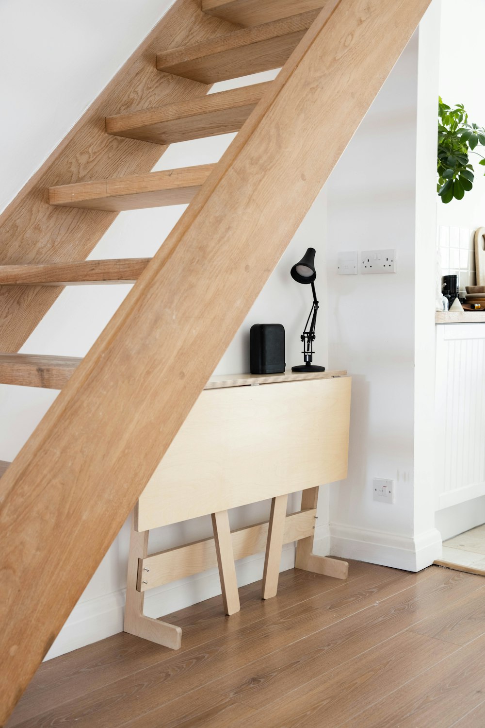 brown wooden staircase near white wooden table